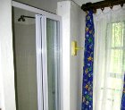 Large bathroom with full length bath, double sized shower, wash basin and toilet in Lothlorien Cottage in Hogsback, South Africa